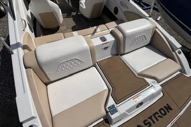 Slide: The Image of 2018 Glastron GT 187 boat interior with beige and white seating, showcasing modern design. - 10