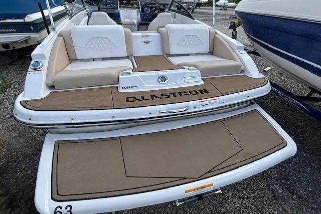 Slide: The Image of 2018 Glastron GT 187 boat with spacious seating and sleek design. - 14