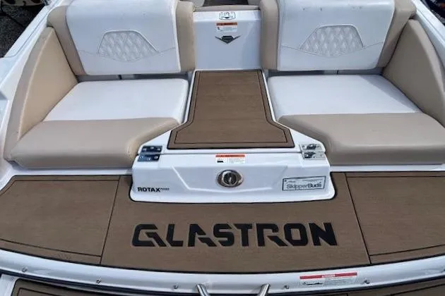 Slide: The Image of 2018 Glastron GT 187 boat interior with cushioned seating and branded flooring. - 15