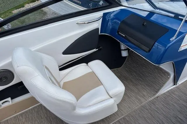 Slide: The Image of 2018 Glastron GT 187 boat interior with white seating and blue dashboard. - 21