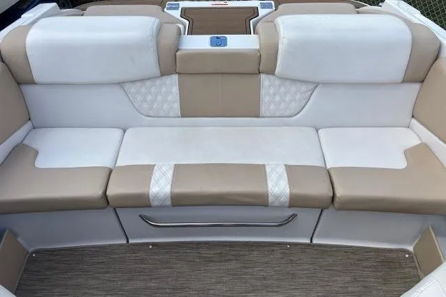 Slide: The Image of 2018 Glastron GT 187 boat interior with beige and white cushioned seating. - 22