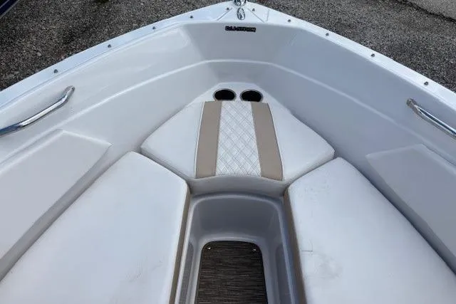 Slide: The Image of 2018 Glastron GT 187 boat interior with cushioned seating and cup holders. - 23