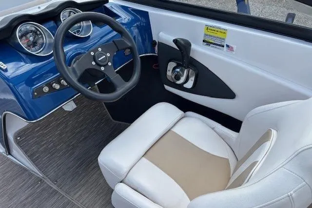 Slide: The Image of 2018 Glastron GT 187 boat interior with steering wheel and control panel. - 25