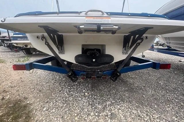 Slide: The Image of 2018 Glastron GT 187 boat on trailer, rear view, parked on gravel. - 26