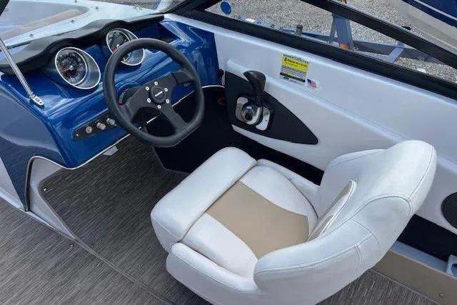 Slide: The Image of 2018 Glastron GT 187 boat interior with steering wheel and captain's seat. - 5