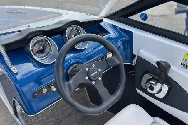 Slide: The Image of 2018 Glastron GT 187 boat dashboard with steering wheel and gauges. - 6