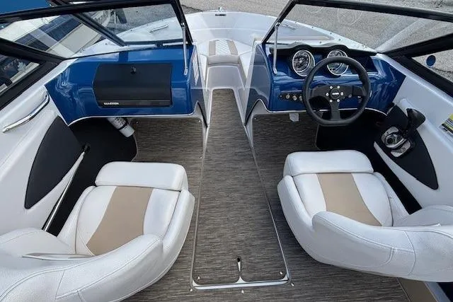 Slide: The Image of 2018 Glastron GT 187 boat interior with white seats, blue dashboard, and steering wheel. - 8