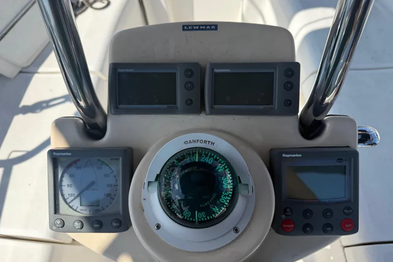 Slide: The Image of Cockpit instruments of a 2007 Hunter 31 sailboat, featuring Raymarine displays and a Danforth compass. - 13