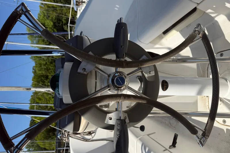 Slide: The Image of Steering wheel of a 2007 Hunter 31 sailboat, featuring a modern helm design. - 17