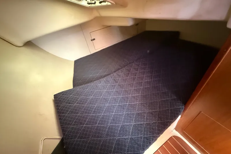 Slide: The Image of 2007 Hunter 31 sailboat interior cabin with blue patterned bedding. - 5