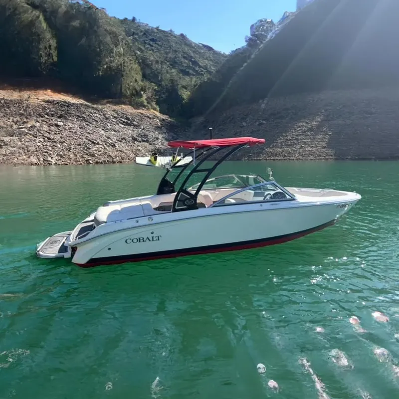 The Image of 2017 Cobalt 220S boat with red canopy on a serene lake. - 0