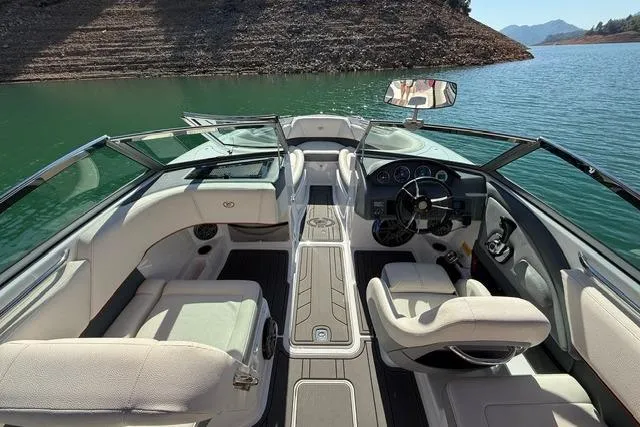 Slide: The Image of 2017 Cobalt 220S boat interior with seating, steering wheel, and lake view. - 3