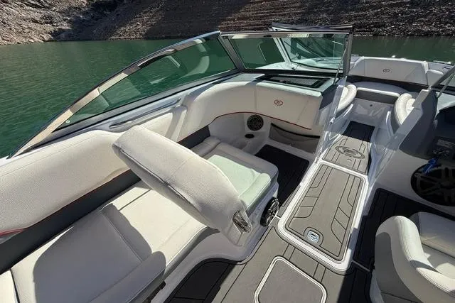 Slide: The Image of 2017 Cobalt 220S boat interior with white seating and sleek design on a lake. - 5