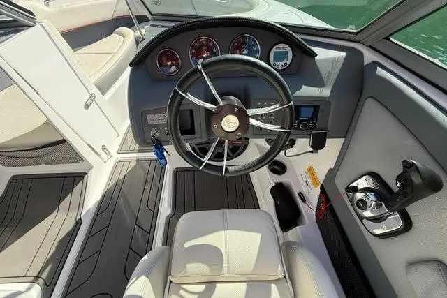 Slide: The Image of 2017 Cobalt 220S boat cockpit with steering wheel and control panel. - 8