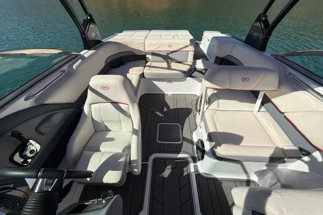 Slide: The Image of 2017 Cobalt 220S boat interior with white seating and sleek design on water. - 9