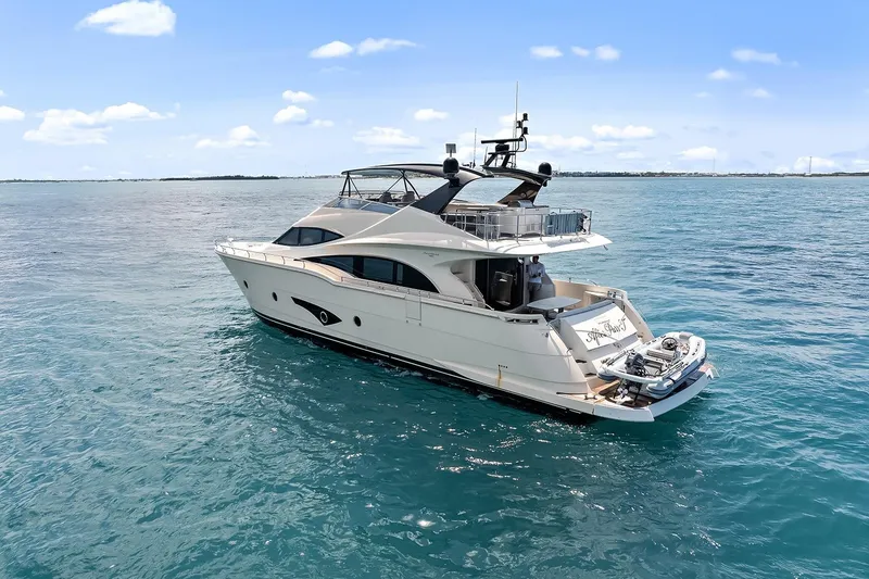 Slide: The Image of Luxurious 2016 Marquis 720 Fly Bridge yacht cruising on open water. - 10