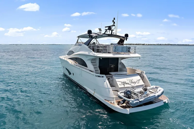 Slide: The Image of Luxury 2016 Marquis 720 Fly Bridge yacht on open sea, clear blue sky. - 11