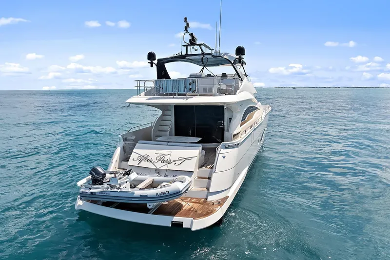 Slide: The Image of Luxury 2016 Marquis 720 Fly Bridge yacht on open sea, clear blue sky. - 12