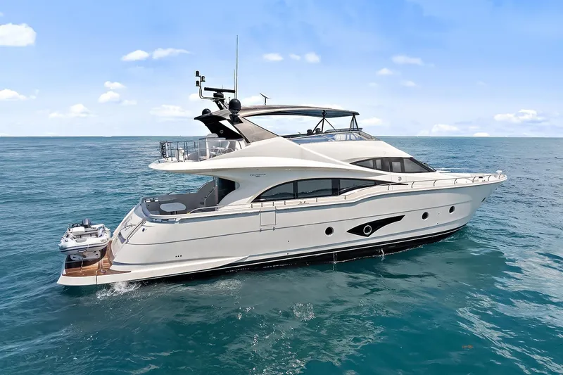 Slide: The Image of Luxury 2016 Marquis 720 Fly Bridge yacht cruising on open sea. - 13