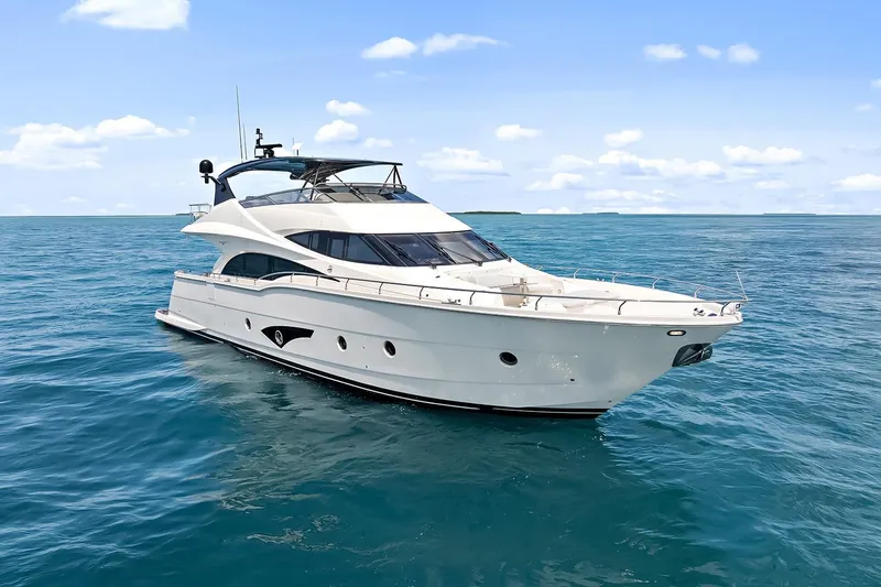 Slide: The Image of Luxury 2016 Marquis 720 Fly Bridge yacht cruising on open sea. - 14