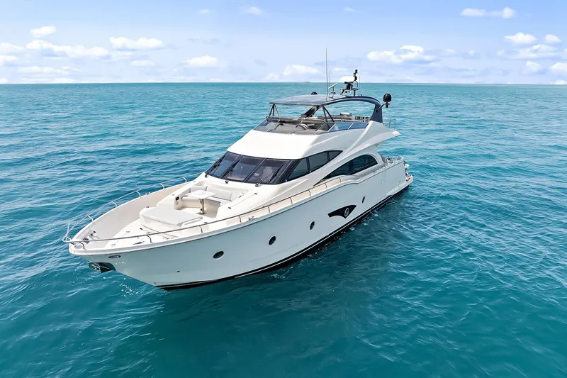 Slide: The Image of Luxury 2016 Marquis 720 Fly Bridge yacht cruising on open sea. - 15