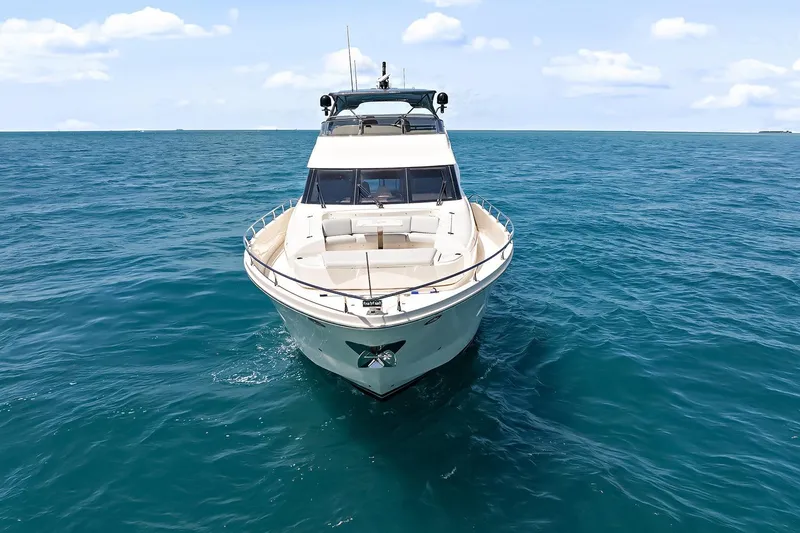 Slide: The Image of 2016 Marquis 720 Fly Bridge yacht cruising on open blue sea. - 16