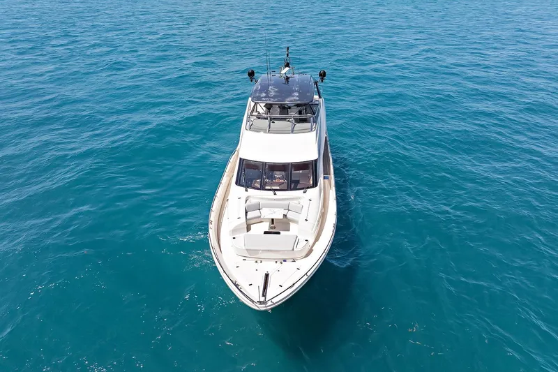 Slide: The Image of Luxury Marquis 720 Fly Bridge yacht cruising on clear blue ocean waters, 2016 model. - 17