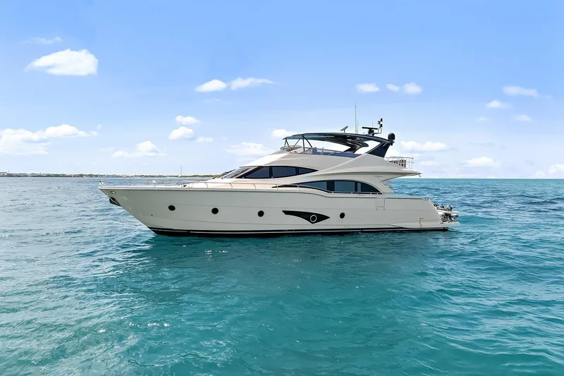 Slide: The Image of Luxury 2016 Marquis 720 Fly Bridge yacht cruising on open sea. - 19