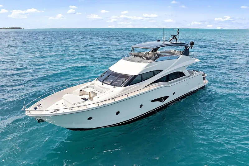 Slide: The Image of Luxurious 2016 Marquis 720 Fly Bridge yacht cruising on clear blue ocean waters. - 21