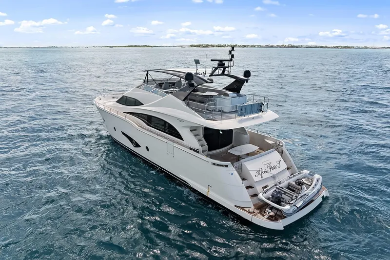 Slide: The Image of Luxury 2016 Marquis 720 Fly Bridge yacht cruising on open water. - 24