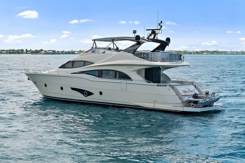 Slide: The Image of Luxury 2016 Marquis 720 Fly Bridge yacht cruising on open water. - 25