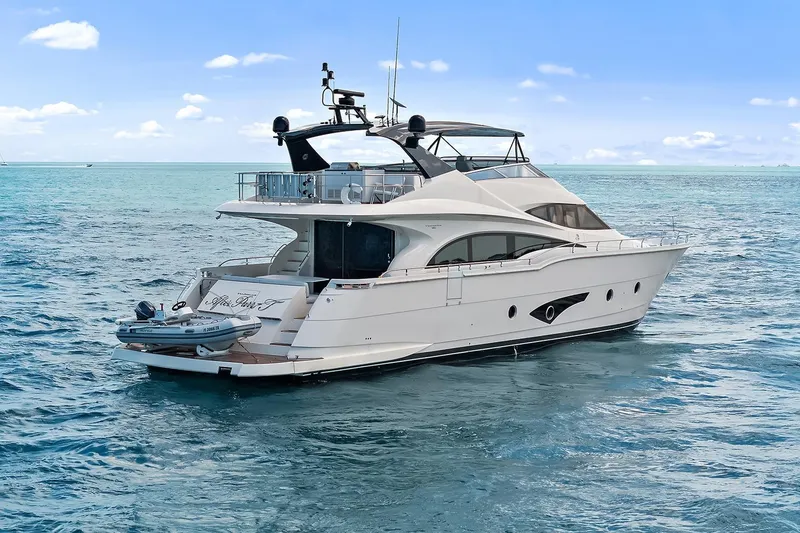 Slide: The Image of Luxury 2016 Marquis 720 Fly Bridge yacht cruising on open sea. - 26