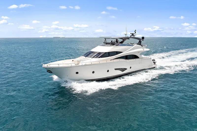 Slide: The Image of Luxury 2016 Marquis 720 Fly Bridge yacht cruising on open sea. - 3