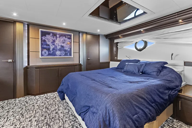 Slide: The Image of Luxurious bedroom in 2016 Marquis 720 Fly Bridge yacht with blue bedding and modern decor. - 30