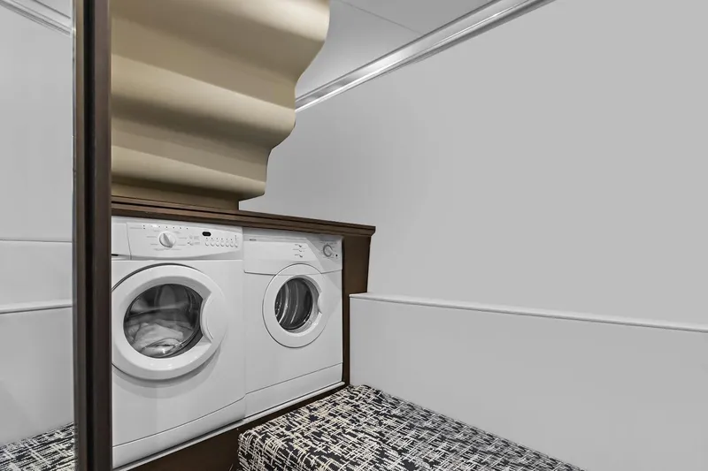 Slide: The Image of Laundry area in 2016 Marquis 720 Fly Bridge yacht with washer and dryer. - 31
