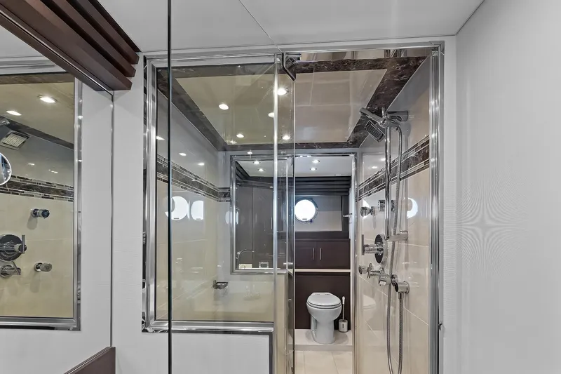 Slide: The Image of Luxurious bathroom on 2016 Marquis 720 Fly Bridge yacht with modern shower and porthole window. - 34