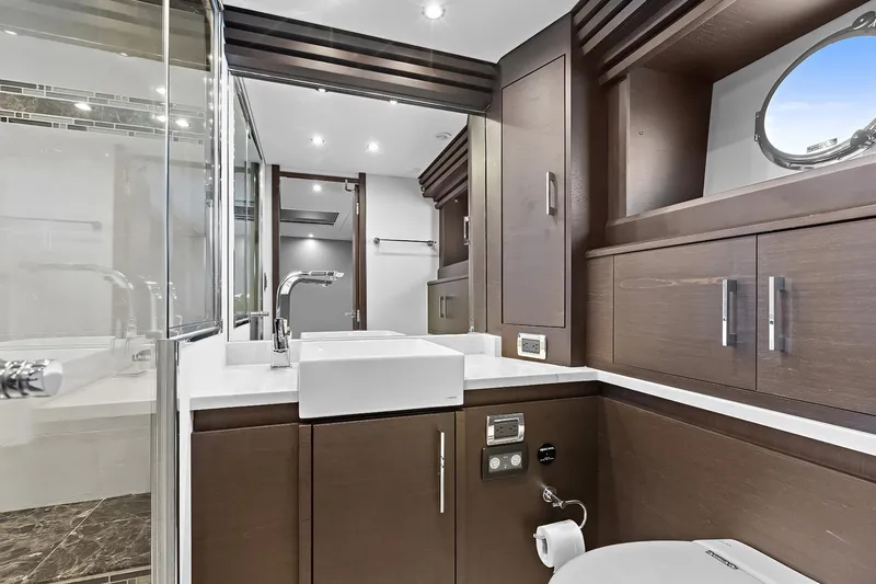 Slide: The Image of Luxurious bathroom in 2016 Marquis 720 Fly Bridge yacht with modern fixtures and wood cabinetry. - 35