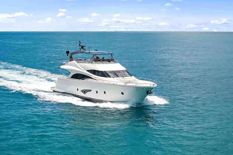 Slide: The Image of Luxury 2016 Marquis 720 Fly Bridge yacht cruising on open sea. - 4