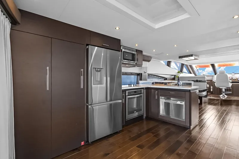 Slide: The Image of Luxurious interior of 2016 Marquis 720 Fly Bridge yacht with modern kitchen and seating area. - 43