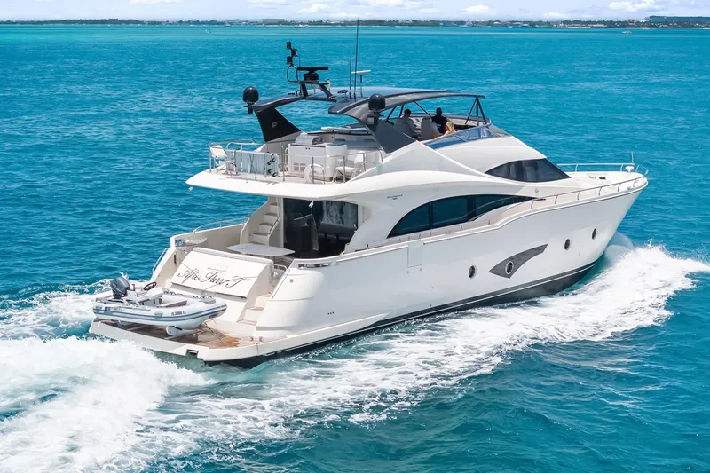 Slide: The Image of Luxurious 2016 Marquis 720 Fly Bridge yacht cruising on clear blue ocean waters. - 5