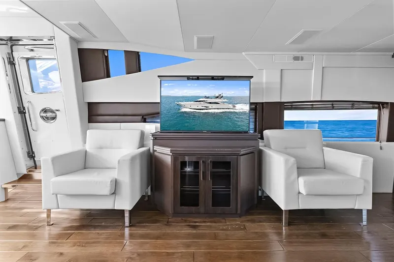 Slide: The Image of Luxurious interior of 2016 Marquis 720 Fly Bridge yacht with modern seating and ocean view. - 53