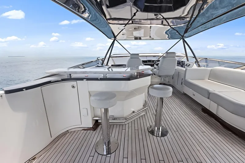 Slide: The Image of Luxurious 2016 Marquis 720 Fly Bridge yacht interior with sleek seating and ocean view. - 60