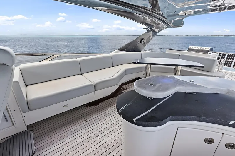 Slide: The Image of Luxurious 2016 Marquis 720 Fly Bridge yacht with elegant seating and ocean view. - 61