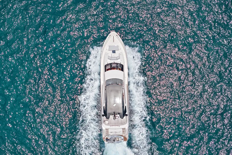 Slide: The Image of Aerial view of 2016 Marquis 720 Fly Bridge yacht cruising on sparkling blue water. - 7