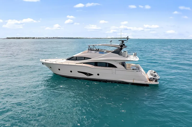 Slide: The Image of Luxury 2016 Marquis 720 Fly Bridge yacht cruising on open sea. - 9