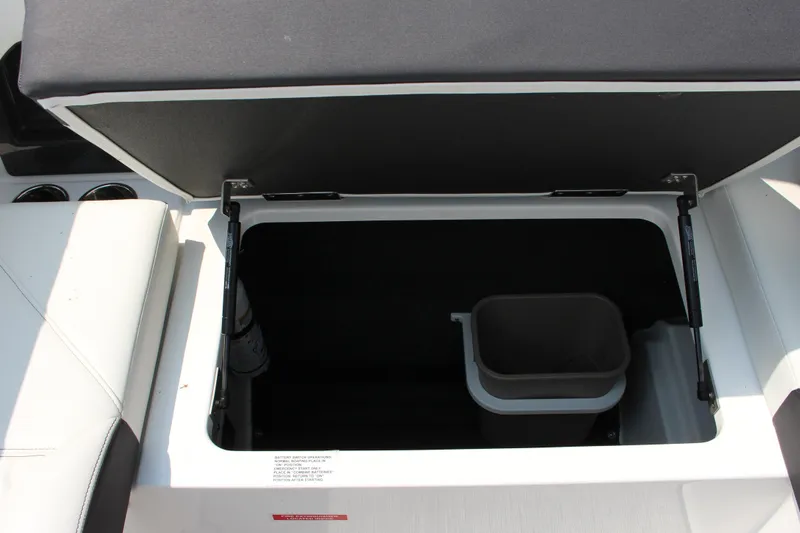 Slide: The Image of Open storage compartment in 2025 Cobalt R4 boat with trash bin. - 15