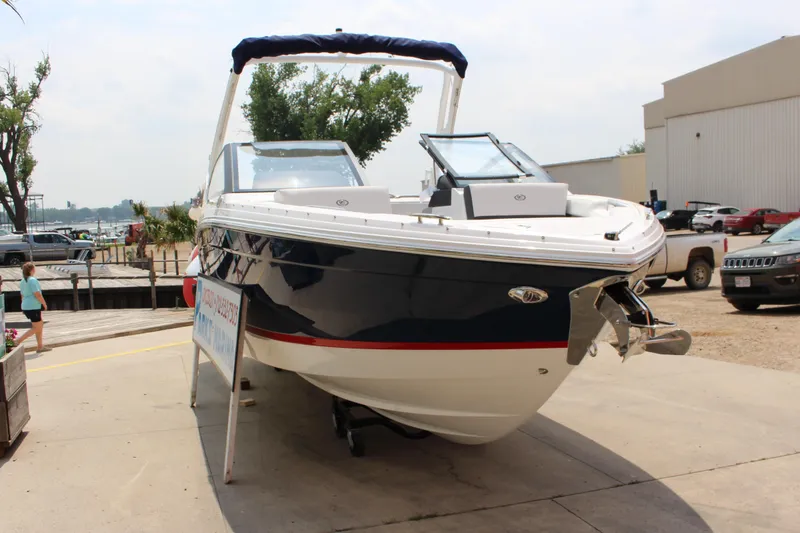 Slide: The Image of 2025 Cobalt R4 boat displayed outdoors on a sunny day. - 2