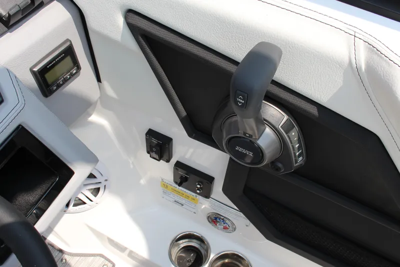 Slide: The Image of Interior controls of a 2025 Cobalt R4 boat, featuring throttle and digital display. - 25