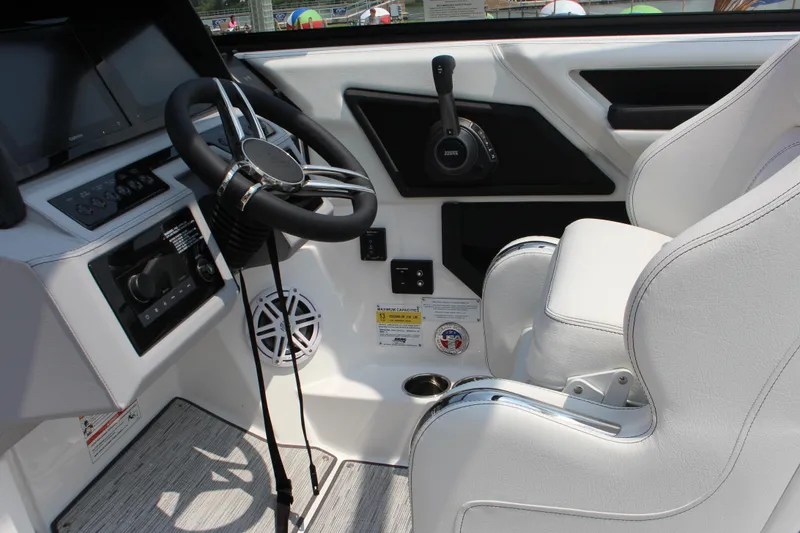 Slide: The Image of Interior of 2025 Cobalt R4 boat featuring steering wheel and white seating. - 27