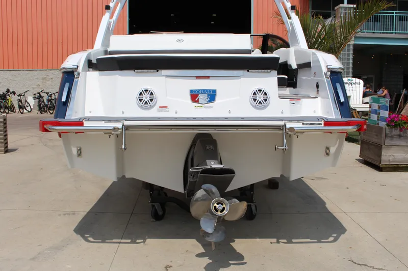 Slide: The Image of 2025 Cobalt R4 boat rear view with propeller and dockside setting. - 7